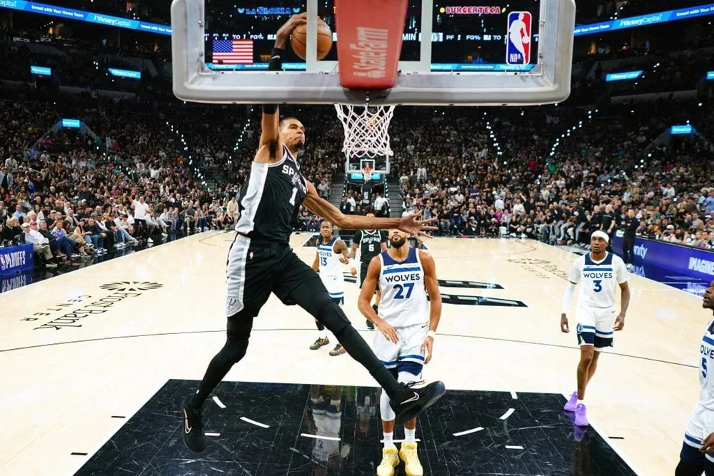 May 12, 2026; San Antonio, Texas, USA; San Antonio Spurs forward Victor Wembanyama (1) dunks ahead of Minnesota Timberwolves center Rudy Gobert (27) and forward Jaden McDaniels (3) during the first half of game five of the second round of the 2026 NBA Playoffs at Frost Bank Center. Mandatory Credit: Scott Wachter-Imagn Images
